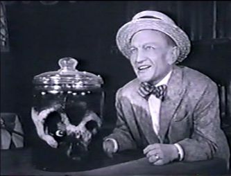 Screenshot of the Alfred Hitchcock version of the story. That's Billy Barty posing with the jar in the 1964 episode.