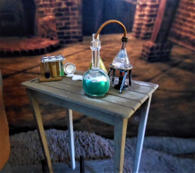 Detail shot of the laboratory table. I didn't care for the Bunsen burner stand so I made one out of a pairs of hair pins and a washer.