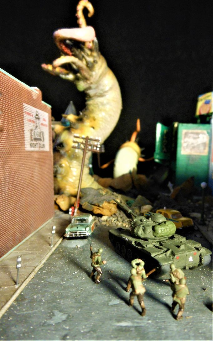 A tank and a squad of soldiers trying to get the drop on the big fella. There are many soldiers scattered throughout the diorama but they're hard to see because of their small scale. Click for a larger image.