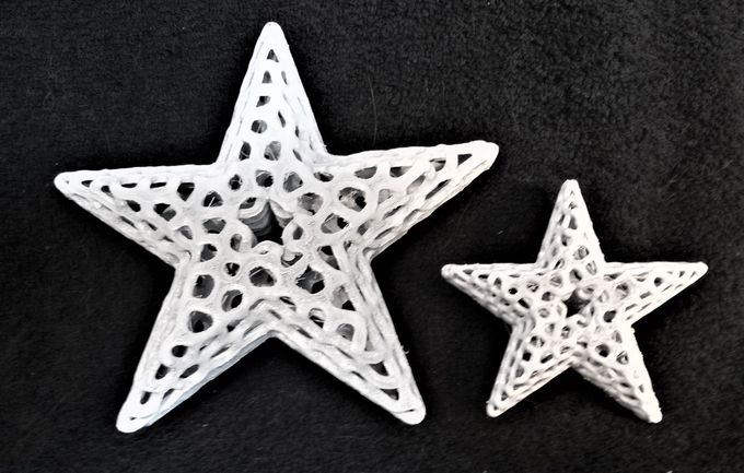 Two voronoi star fish. The smaller star fish on the right is the actual 'recipe' measuring about four inches across. The one of the left is a larger and flatter version which illustrates the ability one has in 3D printing that allow the user to alter and objects size & dimensions as they like, the only limitation in size being that of the 3D printer itself.